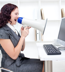 Businesswoman yelling through a megaphone