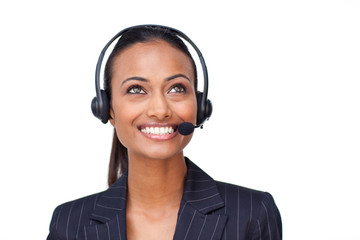 Beautiful ethnic businesswoman with a headset on looking upwards