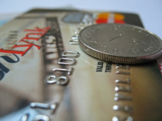A credit card with 1 dirham coin