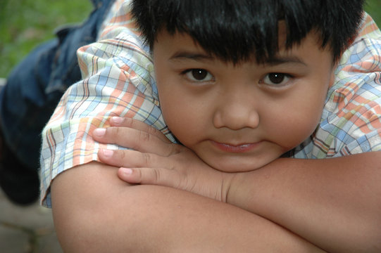 little boy get laying in the park
