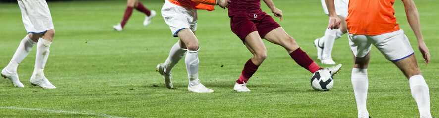 Soccer players fighting for the ball