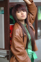 young lady wearing brown leather jacket