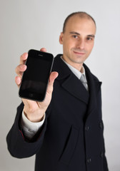 It's for you. (Businessman holding a mobile phone)