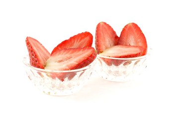 Strawberry halves in glass dishes