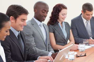 Fototapeta premium Business people in a meeting taking notes