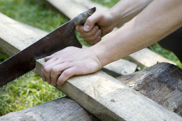 fragment of man`s hand saw log