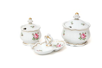 Two porcelain sugar basins and jam dish with roses isolated