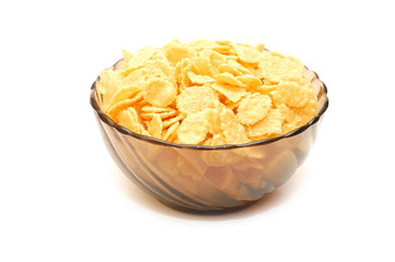 Transparent bowl with corn flakes on white background