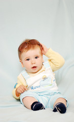 baby boy on blue smiling