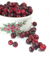 Ripe cranberries in a pottery dish
