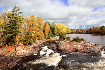 Fototapeta na wymiar Cascading River and Fall Colors