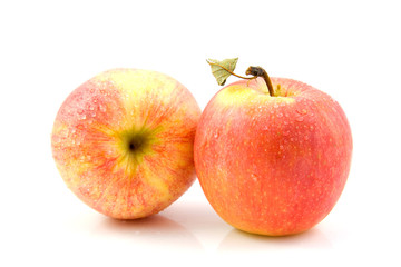two fresh juicy apples with water drops over white background