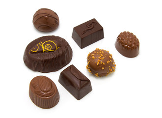 tasty chocolate bonbons over white background