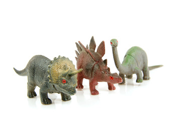 Couple of dinosaur toys on white background