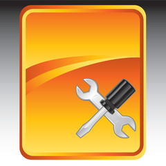 Screwdrive and wrench on orange advertisement