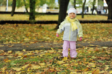 girl playing in autumn park