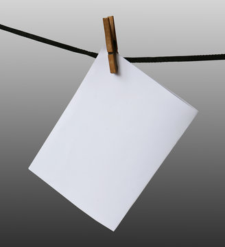 blank paper hanging on a rope