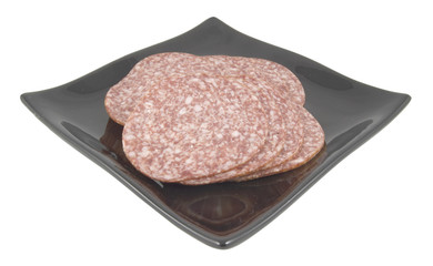 salami slices on plate isolated on white background