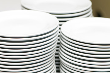 Stacks of empty white plates