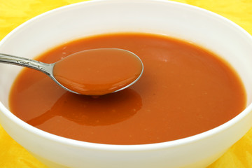 Serving of tomato soup in a white bowl