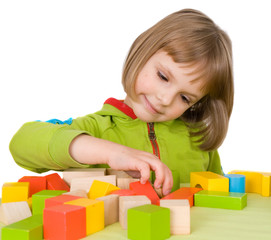 child plays with toy blocks