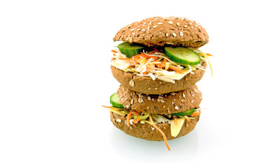 Two brown sandwiches filled with cheese and lettuce