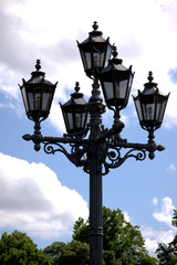 Fototapeta na wymiar Street lamp on cloudy sky