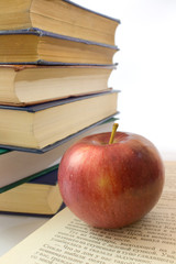 Red apple and pile of books