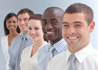 Fototapeta premium Business team in a line. Focus on an Afro-American man