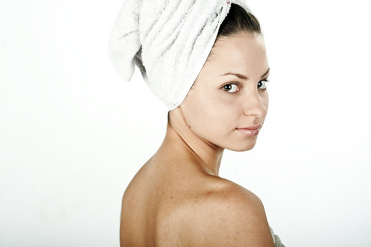 Beautiful young woman enjoying spa on white background