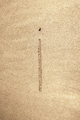 Alphabet letter I handwritten in sand