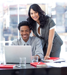 Businesswoman and businessman working with a laptop