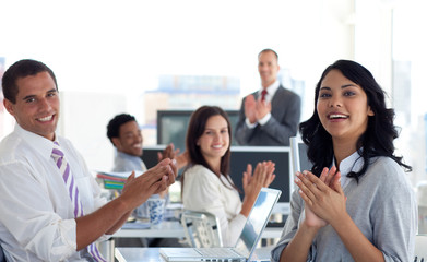 Businessteam applauding a colleague after a presentation