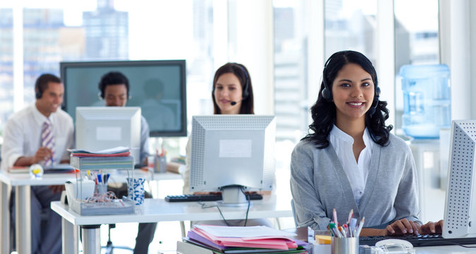 Businesswoman with a headset on in a call center