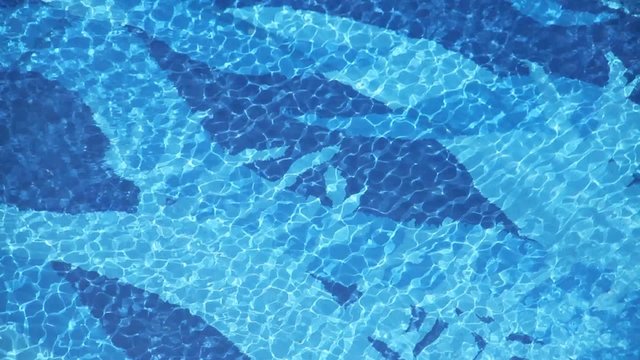 Swimming pool water texture with swimmer passing by two corner.