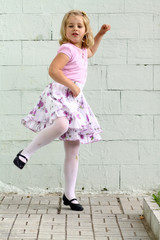 Small funny girl playing outdoor in park