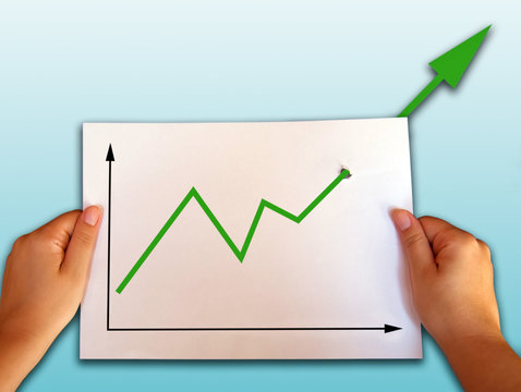 business graph rising through the paper
