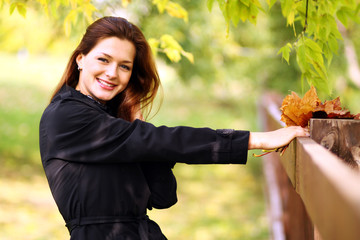 Beautiful woman with diadem made from yellow maple leaves .