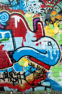 Fototapeta Abstract graffiti on the textured brick wall