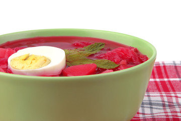 fresh beet vegetable soup in green bowl