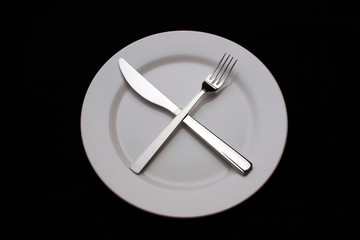 Plate and crossed cutlery