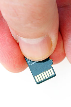 Hand holding mmc flash on the white background