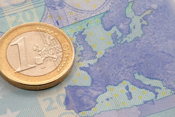 Euro coin on euro banknote