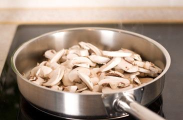 Frying mushrooms in the frying pan