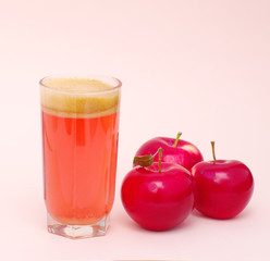 glass with fresh neat juice and red apples
