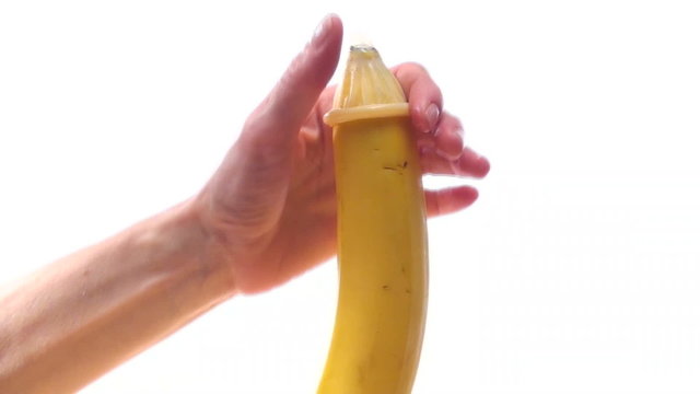 Putting condom on banana - HD