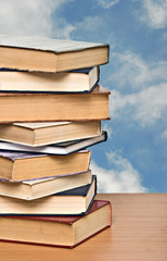 Pile of books  on desk