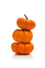 Stack of pumpkins on white