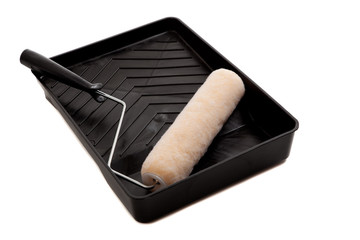 A paint pan with roller on white