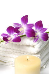 A beautiful orchid , towel and candle
